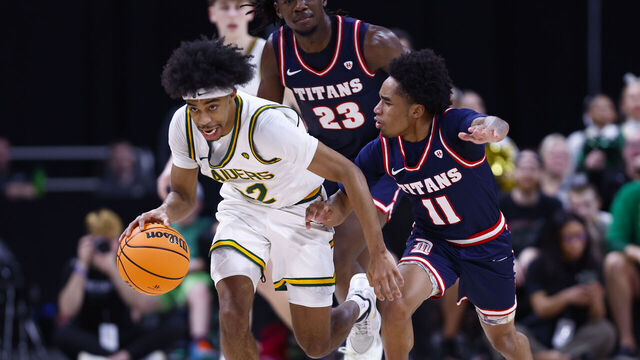 INDIANAPOLIS, IN - MARCH 10: Wright State Raiders guard TJ Burch (22) scoops up the loose ball while defended by Detroit Mercy Titans guard Lance Stone (11) in the first half of play during the men's Horizon League Tournament Championship basketball game between the Wright State Raiders and the Detroit Mercy Titans on March 10, 2026 at Corteva Coliseum in Indianapolis, IN.