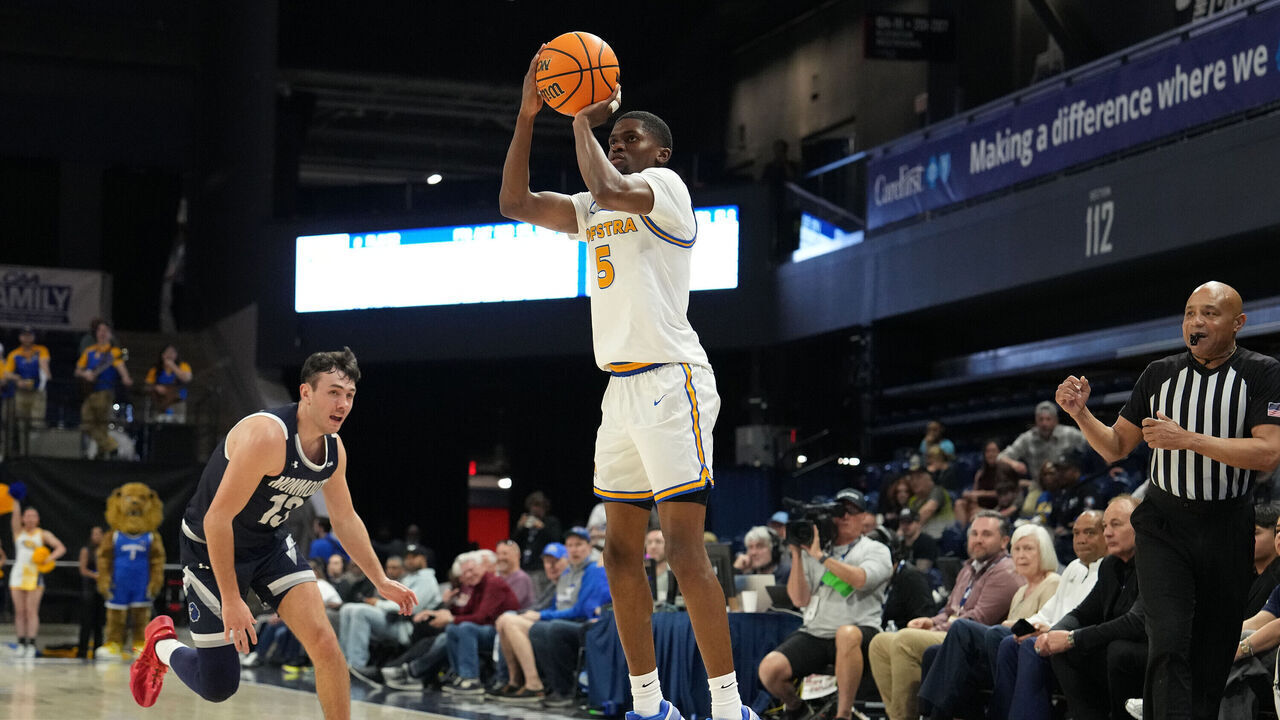 WASHINGTON, DC - MARCH 10: Cruz Davis #5 of the Hofstra Pride takes a jump shot over Jack Collins #13 of the Monmouth Hawks in the first half of the CAA Men's Basketball Championship game at the CareFirst Arena on March 10, 2026 in Washington, DC.