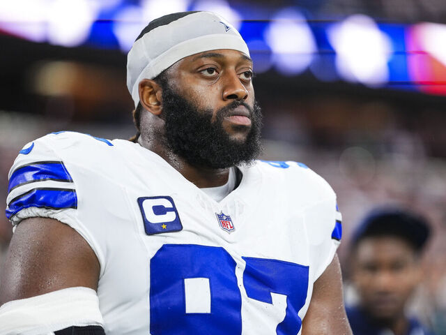 ARLINGTON, TX - NOVEMBER 23: Osa Odighizuwa #97 of the Dallas Cowboys looks on from the sideline during the national anthem prior to an NFL football game against the Philadelphia Eagles at AT&T Stadium on November 23, 2025 in Arlington, Texas.
