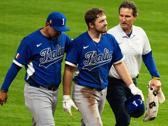 HOUSTON, TEXAS - MARCH 10: Kyle Teel #3 of Italy is escorted off the field after being injured running to second base in the sixth inning during the World Baseball Classic Pool B game between Italy and the United States at Daikin Park on March 10, 2026 in Houston, Texas.