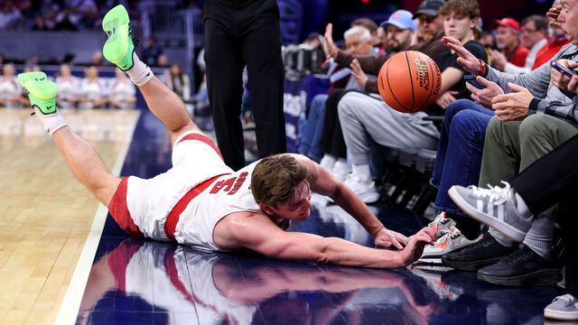 CLEVELAND, OH - MARCH 12: Miami (OH) RedHawks guard Peter Suder (5) dives out of bounds for the basketball during the first half of the MAC Men's Basketball Tournament Quarterfinal game between the Miami (OH) RedHawks and UMass Minutemen on March 12, 2026, at Rocket Arena in Cleveland, OH.