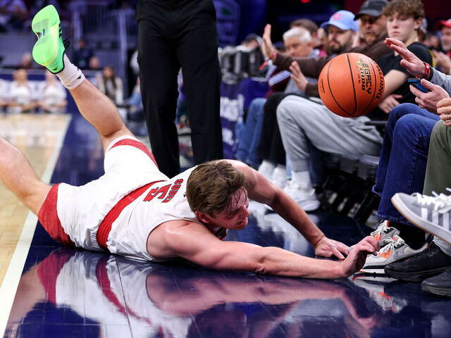 CLEVELAND, OH - MARCH 12: Miami (OH) RedHawks guard Peter Suder (5) dives out of bounds for the basketball during the first half of the MAC Men's Basketball Tournament Quarterfinal game between the Miami (OH) RedHawks and UMass Minutemen on March 12, 2026, at Rocket Arena in Cleveland, OH.