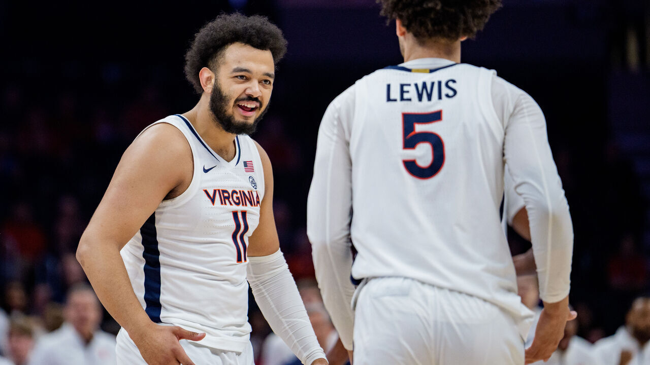CHARLOTTE, NORTH CAROLINA - MARCH 12: Devin Tillis #11 celebrates with Sam Lewis #5 of the Virginia Cavaliers in the first half against the NC State Wolfpack during the quarterfinals of the 2026 Men's ACC Tournament at Spectrum Center on March 12, 2026 in Charlotte, North Carolina.