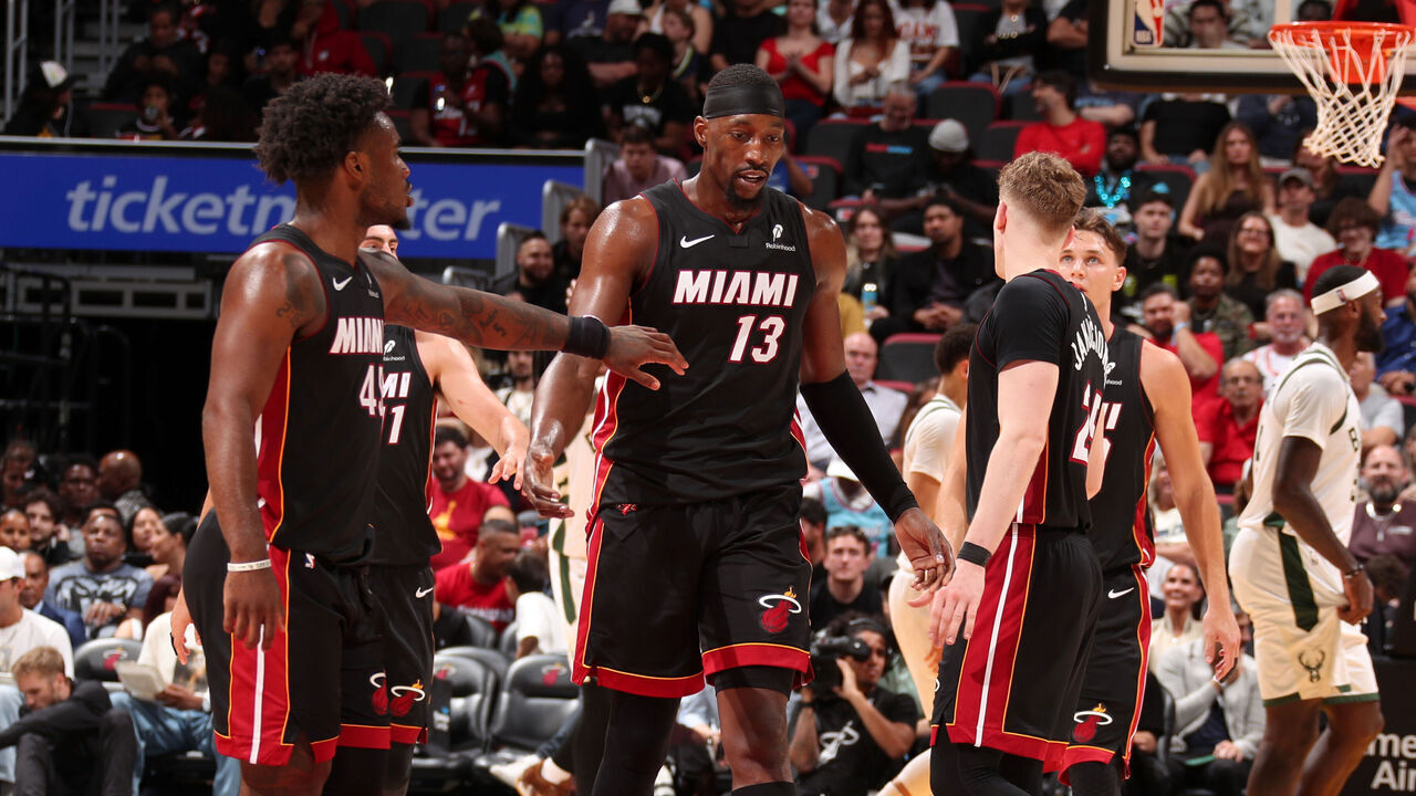 MIAMI, FL - MARCH 12: Bam Adebayo #13 and Davion Mitchell #45 of the Miami Heat high five during the game against the Milwaukee Bucks on March 12, 2026 at Kaseya Center in Miami, Florida. Mandatory Copyright Notice: Copyright 2026 NBAE