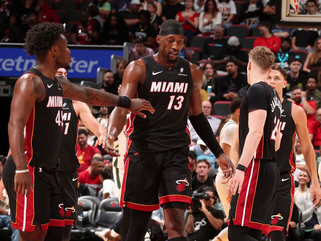 MIAMI, FL - MARCH 12: Bam Adebayo #13 and Davion Mitchell #45 of the Miami Heat high five during the game against the Milwaukee Bucks on March 12, 2026 at Kaseya Center in Miami, Florida. Mandatory Copyright Notice: Copyright 2026 NBAE