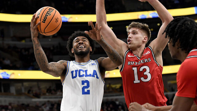 CHICAGO, ILLINOIS - MARCH 12: Donovan Dent #2 of the UCLA Bruins goes for a layup past Harun Zrno (13) of the Rutgers Scarlet Knights during the third round at the Big Ten Men's Basketball Championships at the United Center on March 12, 2026 in Chicago, Illinois.