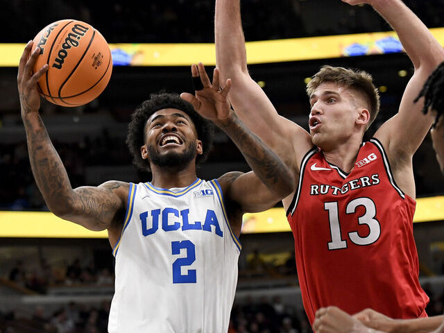 CHICAGO, ILLINOIS - MARCH 12: Donovan Dent #2 of the UCLA Bruins goes for a layup past Harun Zrno (13) of the Rutgers Scarlet Knights during the third round at the Big Ten Men's Basketball Championships at the United Center on March 12, 2026 in Chicago, Illinois.