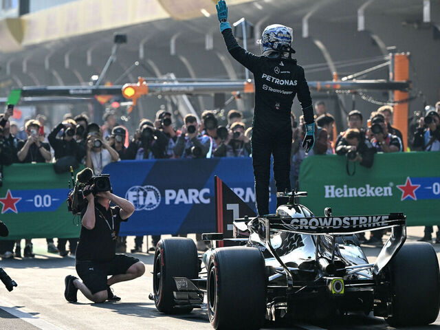 Mercedes' British driver George Russell (C) celebrates getting pole position in the sprint qualifying session ahead of the Formula One Chinese Grand Prix at the Shanghai International Circuit in Shanghai on March 13, 2026.