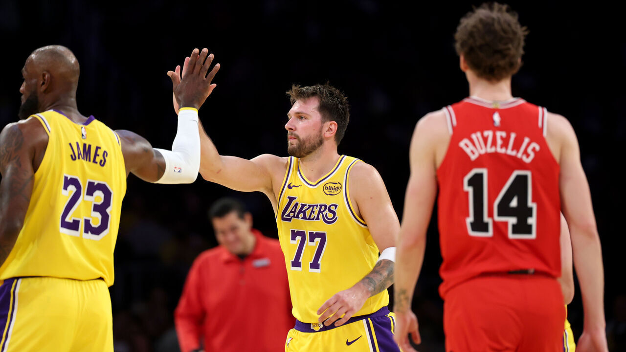 Los Angeles, CA - March 12: Lakers forward LeBron James, #23, and Lakers guard Luka Doncic, #77 high-five as Bulls forward Matas Buzelis, #14, right, watches in the second half at Crypto.com Arena in Los Angeles Thursday, March 12, 2026. (Allen J. Schaben / Los Angeles Times via Getty Images)