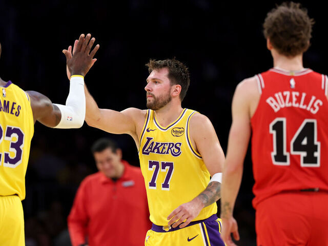 Los Angeles, CA - March 12: Lakers forward LeBron James, #23, and Lakers guard Luka Doncic, #77 high-five as Bulls forward Matas Buzelis, #14, right, watches in the second half at Crypto.com Arena in Los Angeles Thursday, March 12, 2026. (Allen J. Schaben / Los Angeles Times via Getty Images)