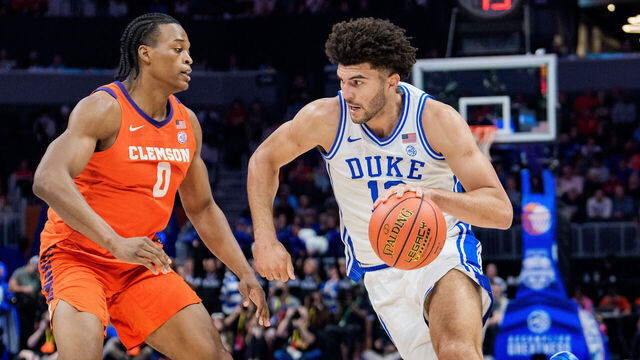 CHARLOTTE, NORTH CAROLINA - MARCH 13: Cameron Boozer #12 of the Duke Blue Devils drives to the basket while guarded by RJ Godfrey #0 of the Clemson Tigers in the first half during the semifinals of the men's ACC Tournament at Spectrum Center on March 13, 2026 in Charlotte, North Carolina.