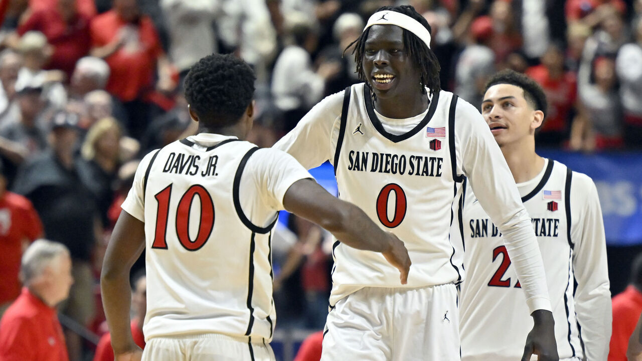 LAS VEGAS, NEVADA - MARCH 13: BJ Davis #10 and Magoon Gwath #0 of the San Diego State Aztecs celebrate Davis' game-winning shot against the New Mexico Lobos during the second half of a semifinal game of the Mountain West Conference men's basketball tournament at the Thomas & Mack Center on March 13, 2026 in Las Vegas, Nevada. The Aztecs defeated the Lobos 64-42.