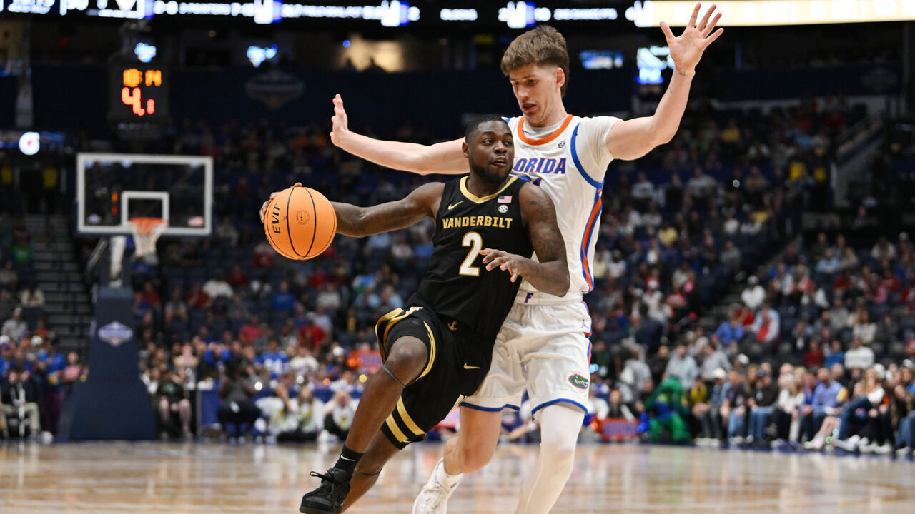 NASHVILLE, TENNESSEE - MARCH 14: Duke Miles #2 of the Vanderbilt Commodores drives around Alex Condon #21 of the Florida Gators during the second half in the semifinal game of the 2026 SEC Men's Basketball Tournament at Bridgestone Arena on March 14, 2026 in Nashville, Tennessee.