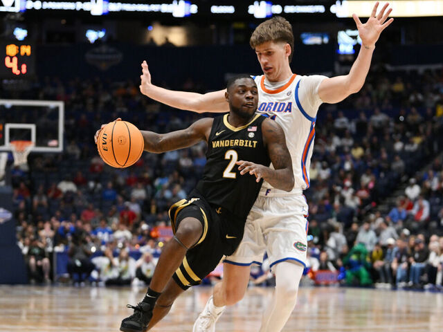 NASHVILLE, TENNESSEE - MARCH 14: Duke Miles #2 of the Vanderbilt Commodores drives around Alex Condon #21 of the Florida Gators during the second half in the semifinal game of the 2026 SEC Men's Basketball Tournament at Bridgestone Arena on March 14, 2026 in Nashville, Tennessee.