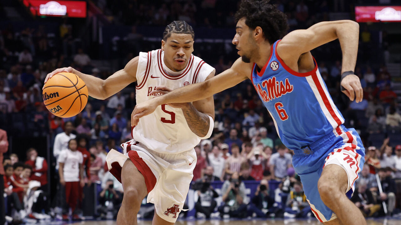 NASHVILLE, TENNESSEE - MARCH 14: Darius Acuff Jr. #5 of the Arkansas Razorbacks drives around Ilias Kamardine #6 of the Ole Miss Rebels during the first half in the semifinal game of the 2026 SEC Men's Basketball Tournament at Bridgestone Arena on March 14, 2026 in Nashville, Tennessee.
