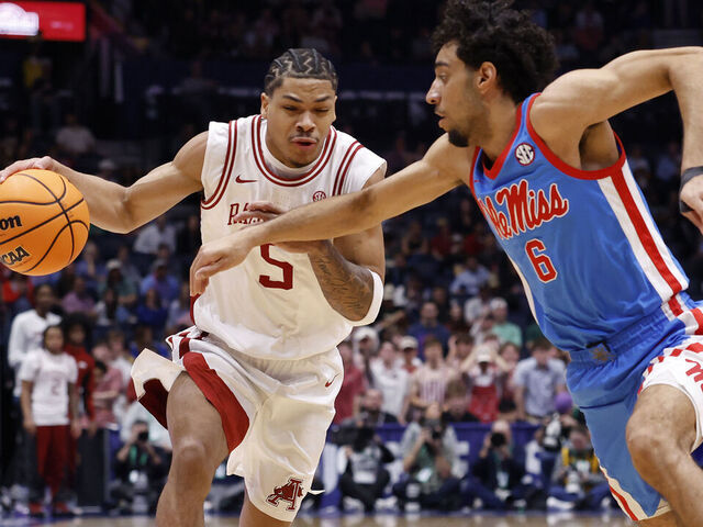 NASHVILLE, TENNESSEE - MARCH 14: Darius Acuff Jr. #5 of the Arkansas Razorbacks drives around Ilias Kamardine #6 of the Ole Miss Rebels during the first half in the semifinal game of the 2026 SEC Men's Basketball Tournament at Bridgestone Arena on March 14, 2026 in Nashville, Tennessee.