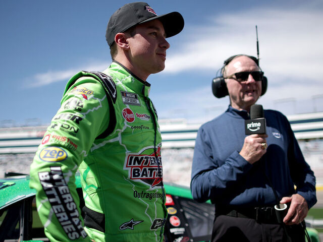 LAS VEGAS, NEVADA - MARCH 14: Christopher Bell, driver of the #20 Interstate Batteries Toyota, (L) speaks to NASCAR on Prime Video analyst, Larry McReynolds on the grid after winning the pole award during qualifying for the NASCAR Cup Series Pennzoil 400 presented by Jiffy Lube at Las Vegas Motor Speedway on March 14, 2026 in Las Vegas, Nevada.
