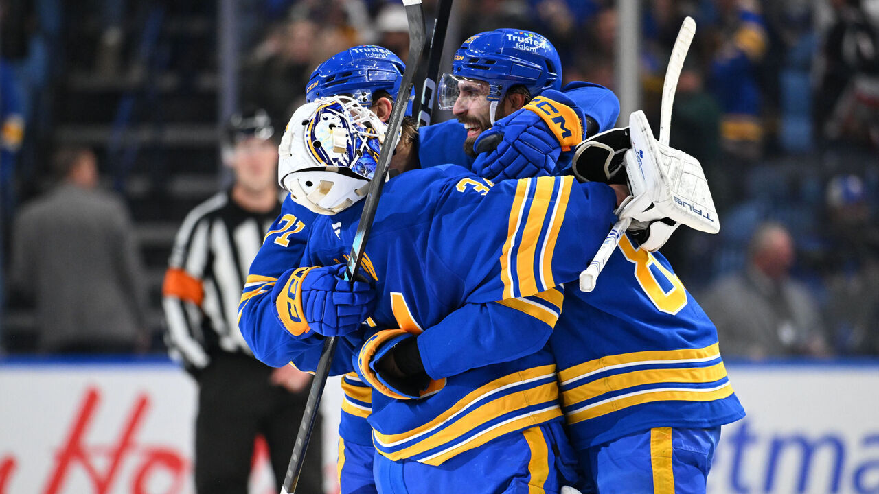 BUFFALO, NEW YORK - MARCH 14: Alex Tuch #89 and Ryan McLeod #71 celebrate with teammate Alex Lyon #34 of the Buffalo Sabres after winning an NHL game against the Toronto Maple Leafs at KeyBank Center on March 14, 2026 in Buffalo, New York. Buffalo won 3-2 in a shootout.