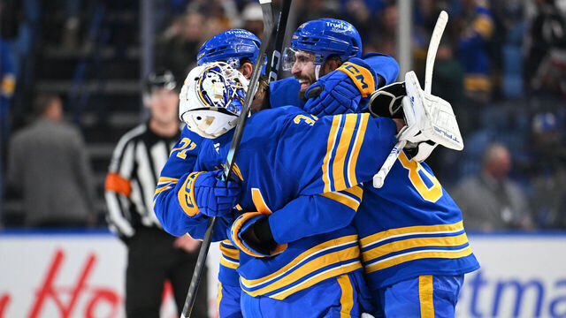 BUFFALO, NEW YORK - MARCH 14: Alex Tuch #89 and Ryan McLeod #71 celebrate with teammate Alex Lyon #34 of the Buffalo Sabres after winning an NHL game against the Toronto Maple Leafs at KeyBank Center on March 14, 2026 in Buffalo, New York. Buffalo won 3-2 in a shootout.