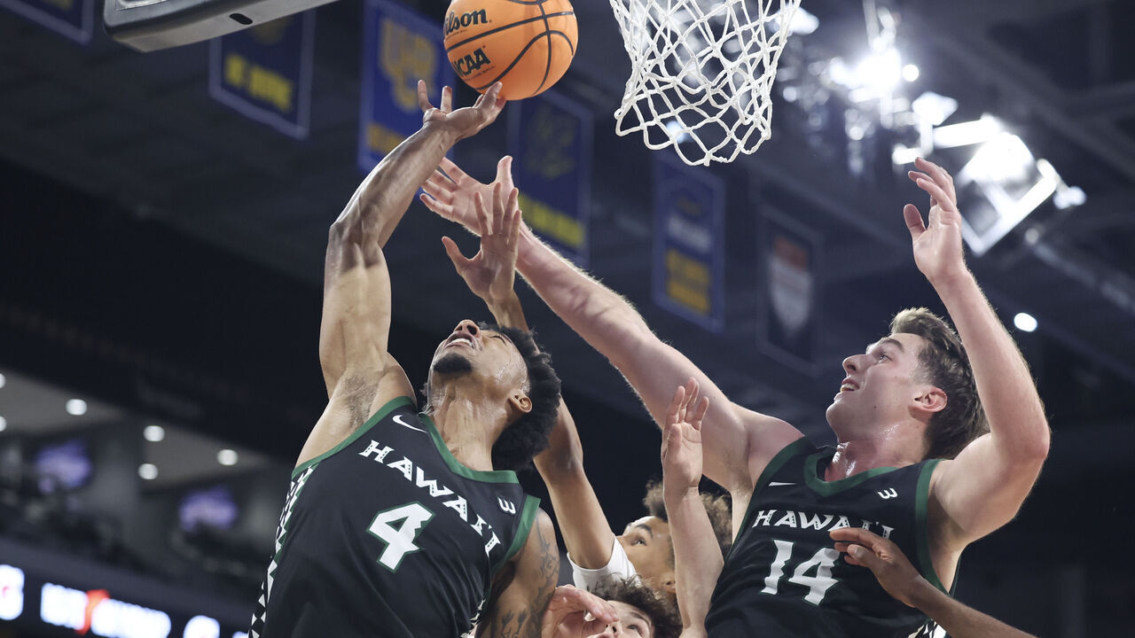 HENDERSON, NEVADA - MARCH 14: Dre Bullock #4 and Harry Rouhliadeff #14 of the Hawaii Rainbow Warriors contest for a rebound against Derin Saran #13 of the UC Irvine Anteaters during the first half of the Big West Conference tournament championship game at Lee's Family Forum on March 14, 2026 in Henderson, Nevada.