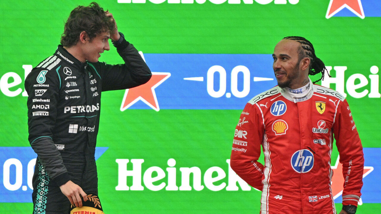 Winner Mercedes' Italian driver Kimi Antonelli (L) and third-placed Ferrari's British driver Lewis Hamilton (R) celebrate on the podium after the Formula One Chinese Grand Prix at the Shanghai International Circuit in Shanghai on March 15, 2026.