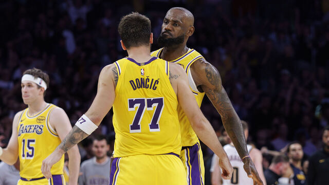 LOS ANGELES, CA - MARCH 14, 2026: Los Angeles Lakers forward LeBron James (23) and Los Angeles Lakers guard Austin Reaves (15) react with Los Angeles Lakers guard Luka Doncic (77) after Doncic scored the game winning basket in overtime against the Denver Nuggets at Crypto.com Arena on March 14, 2026 in Los Angeles, California.(Gina Ferazzi / Los Angeles Times via Getty Images)