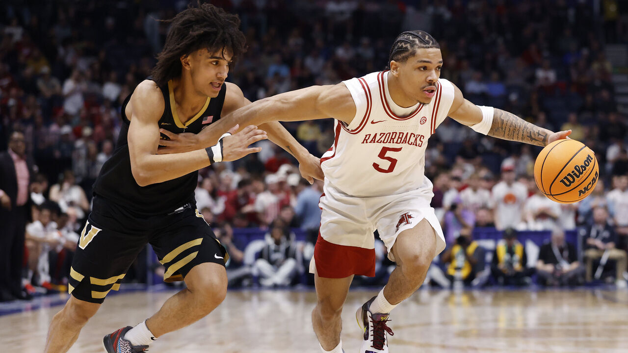 NASHVILLE, TENNESSEE - MARCH 15: Darius Acuff Jr. #5 of the Arkansas Razorbacks drives around Tyler Tanner #3 of the Vanderbilt Commodores in the first half of 2026 SEC Men's Basketball Tournament Championship game at Bridgestone Arena on March 15, 2026 in Nashville, Tennessee.