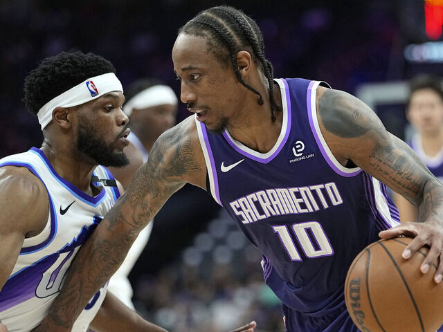 SACRAMENTO, CALIFORNIA - MARCH 15: DeMar DeRozan #10 of the Sacramento Kings dribbling the ball is guarded by Elijah Harkless #16 of the Utah Jazz in the second half at Golden 1 Center on March 15, 2026 in Sacramento, California.