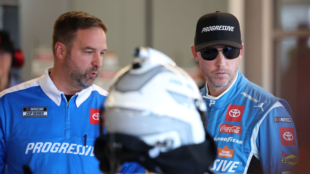 AVONDALE, ARIZONA - OCTOBER 31: Denny Hamlin, driver of the #11 Progressive Toyota, and crew chief Chris Gayle talk in the garage area during practice for the NASCAR Cup Series Championship at Phoenix Raceway on October 31, 2025 in Avondale, Arizona.