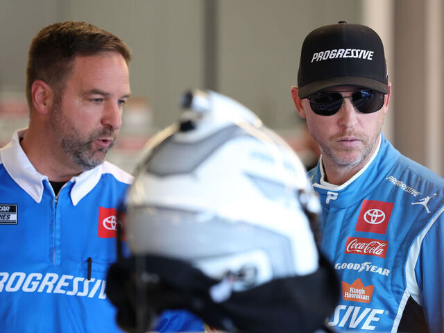 AVONDALE, ARIZONA - OCTOBER 31: Denny Hamlin, driver of the #11 Progressive Toyota, and crew chief Chris Gayle talk in the garage area during practice for the NASCAR Cup Series Championship at Phoenix Raceway on October 31, 2025 in Avondale, Arizona.