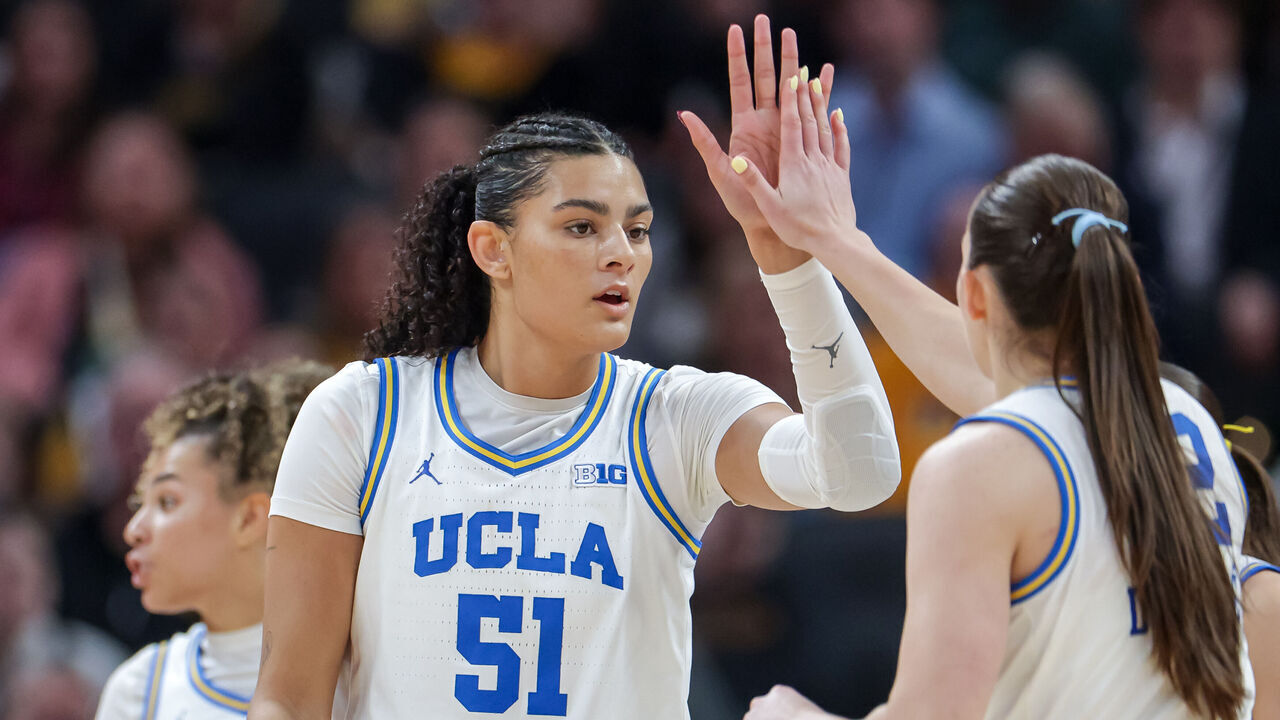 INDIANAPOLIS, INDIANA - MARCH 8: Lauren Betts #51 of the UCLA Bruins high fives with Angela Dugali #32 of the UCLA Bruins during the game against the Iowa Hawkeyes in the Big Ten Women's Basketball Tournament Championship at Gainbridge Fieldhouse on March 8, 2026 in Indianapolis, Indiana.