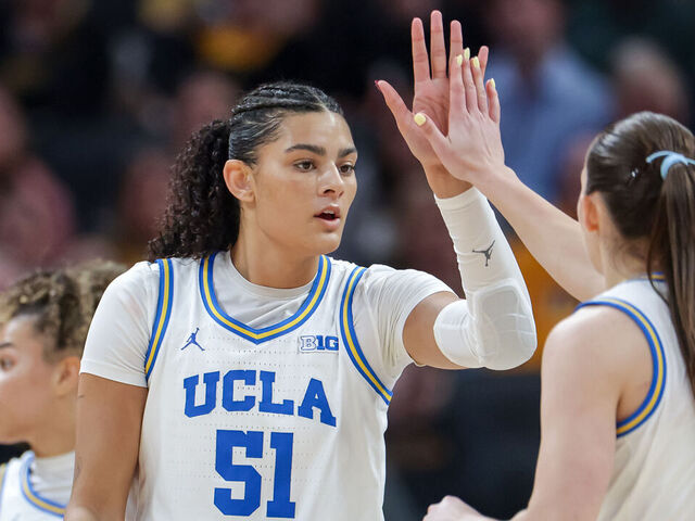 INDIANAPOLIS, INDIANA - MARCH 8: Lauren Betts #51 of the UCLA Bruins high fives with Angela Dugali #32 of the UCLA Bruins during the game against the Iowa Hawkeyes in the Big Ten Women's Basketball Tournament Championship at Gainbridge Fieldhouse on March 8, 2026 in Indianapolis, Indiana.