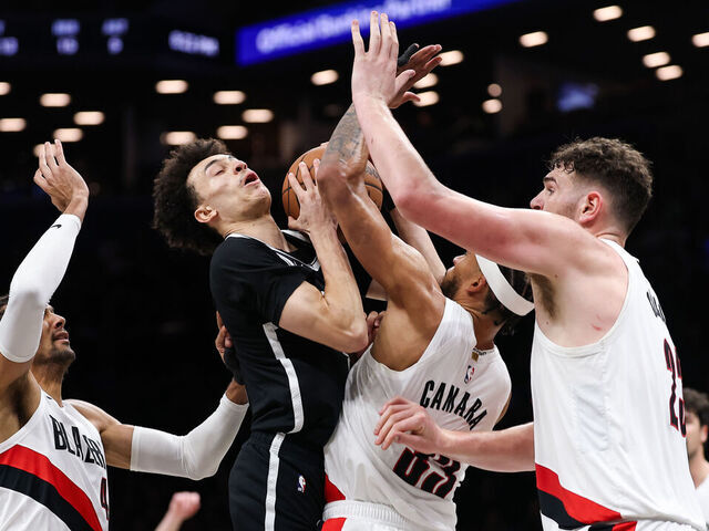 NEW YORK, NEW YORK - MARCH 16: Nolan Traore #88 of the Brooklyn Nets is defended by Toumani Camara #33 and Donovan Clingan #23 and Matisse Thybulle #4 of the Portland Trail Blazers during the second quarter of the game at Barclays Center on March 16, 2026 in New York City.