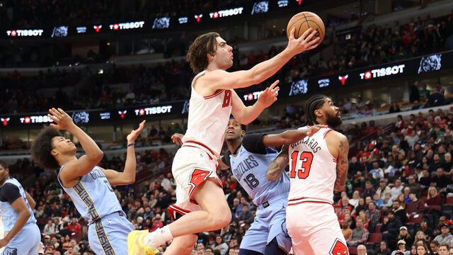 CHICAGO, ILLINOIS - MARCH 16: Josh Giddey #3 of the Chicago Bulls attempts a layup against Jaylen Wells #0 of the Memphis Grizzlies during the second half at the United Center on March 16, 2026 in Chicago, Illinois.