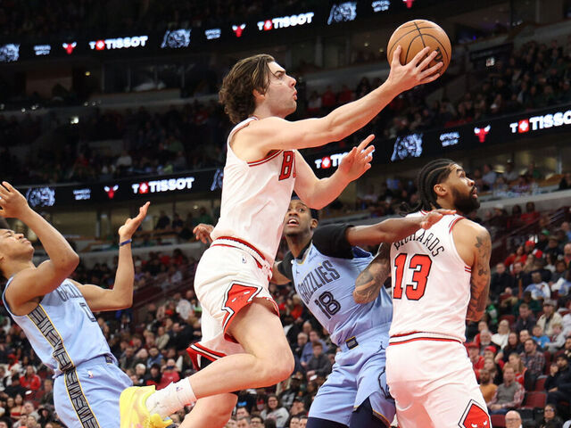 CHICAGO, ILLINOIS - MARCH 16: Josh Giddey #3 of the Chicago Bulls attempts a layup against Jaylen Wells #0 of the Memphis Grizzlies during the second half at the United Center on March 16, 2026 in Chicago, Illinois.