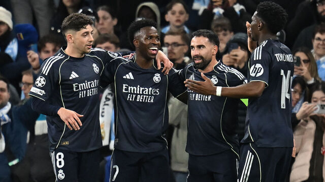 Real Madrid's Brazilian forward #07 Vinicius Junior (2L) celebrates after scoring their late second goal during the UEFA Champions League, round of 16 second leg football match between Manchester City and Real Madrid at the Etihad Stadium in Manchester, north west England, on March 17, 2026.