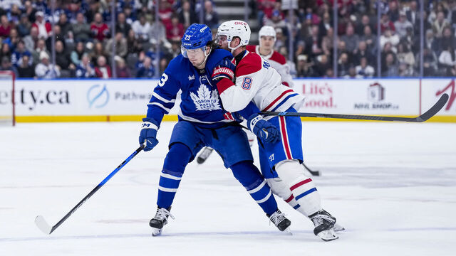 TORONTO, CANADA - DECEMBER 6: Matthew Knies #23 of the Toronto Maple Leafs and Mike Matheson #8 of the Montreal Canadiens battle during the first period at the Scotiabank Arena on December 6, 2025 in Toronto, Ontario, Canada.