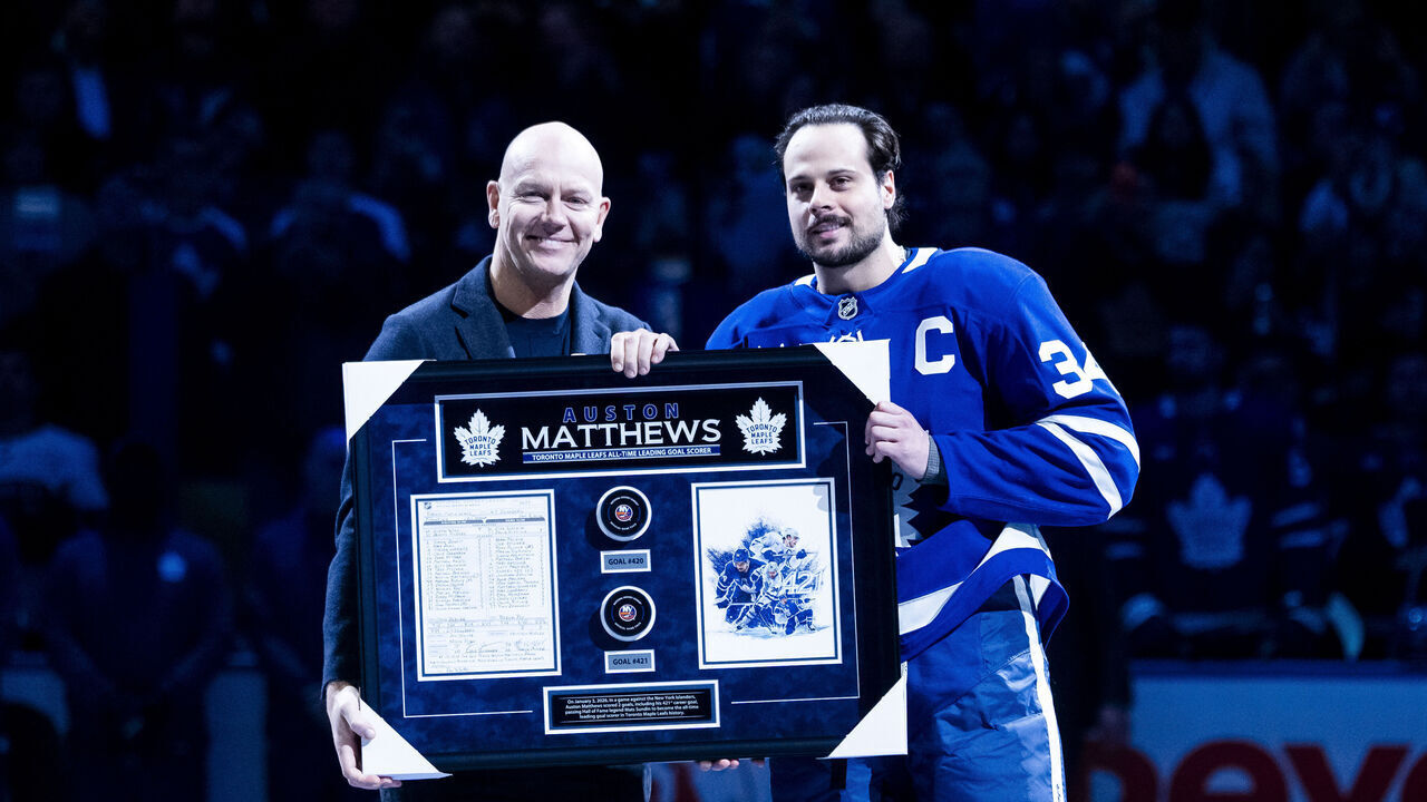 TORONTO, CANADA - JANUARY 6: Toronto Maple Leafs Alumni Matts Sundin presents Auston Matthews #34 of the Toronto Maple Leafs with an award for surpassing his all-time goal scoring record with 421 goals before a game against the Florida Panthers at the Scotiabank Arena on January 6, 2026 in Toronto, Ontario, Canada.
