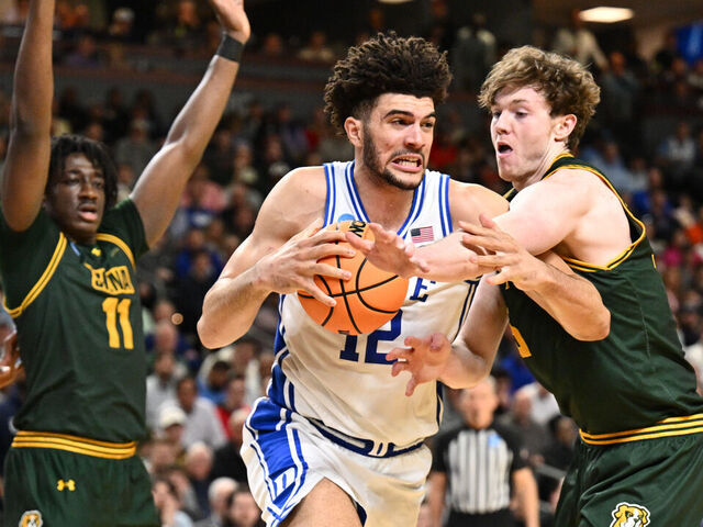 GREENVILLE, SOUTH CAROLINA - MARCH 19: Riley Mulvey #55 of the Siena Saints fouls Cameron Boozer #12 of the Duke Blue Devils during the first round of the 2026 NCAA Men's Basketball Tournament held at Bon Secours Wellness Arena on March 19, 2026 in Greenville, South Carolina.