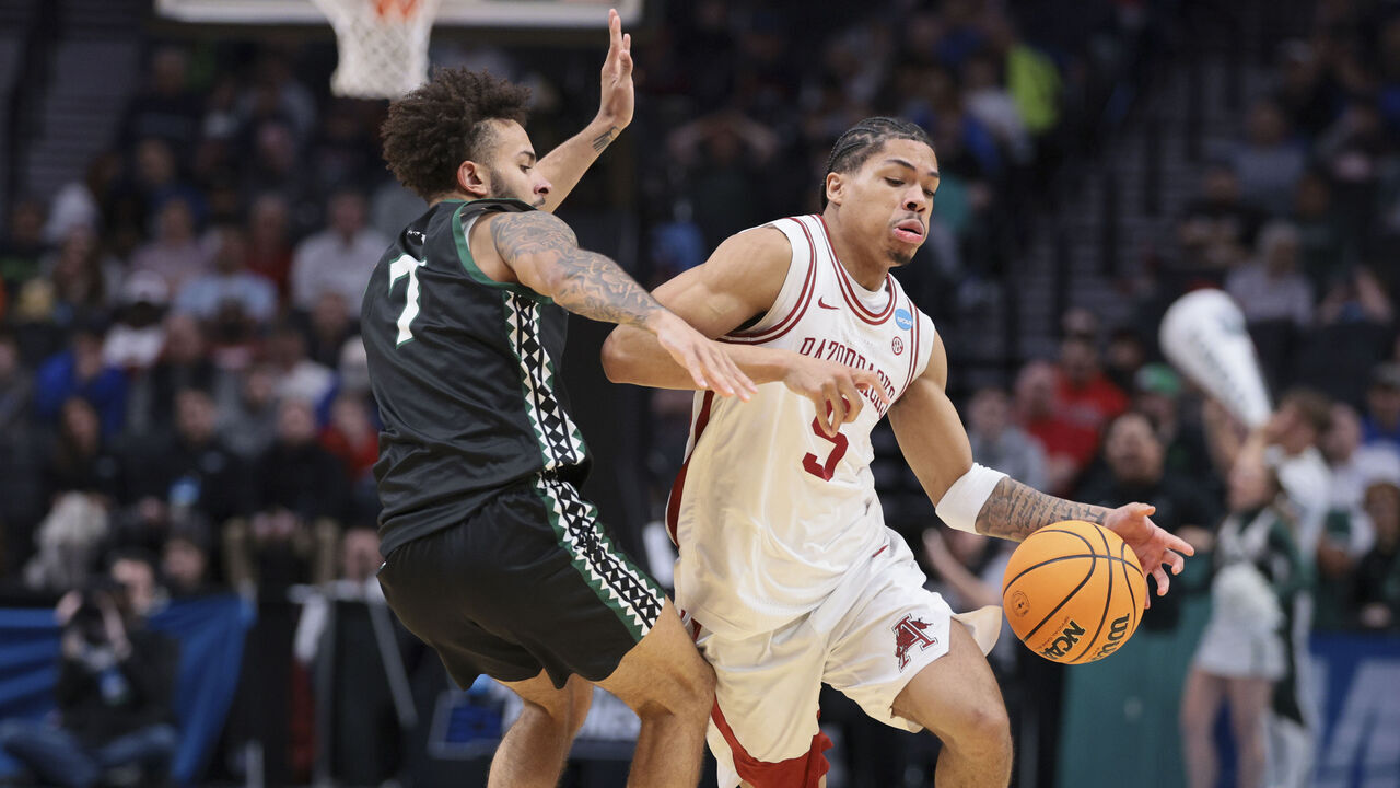 PORTLAND, OREGON - MARCH 19: guard Darius Acuff Jr. #5 of the Arkansas Razorbacks moves the ball against guard Isaiah Kerr #7 of the Hawaii Rainbow Warriors during the second half of the game in the first round of the 2026 NCAA Men's Basketball Tournament held at Moda Center on March 19, 2026 in Portland, Oregon.