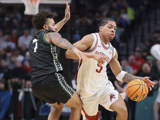 PORTLAND, OREGON - MARCH 19: guard Darius Acuff Jr. #5 of the Arkansas Razorbacks moves the ball against guard Isaiah Kerr #7 of the Hawaii Rainbow Warriors during the second half of the game in the first round of the 2026 NCAA Men's Basketball Tournament held at Moda Center on March 19, 2026 in Portland, Oregon.