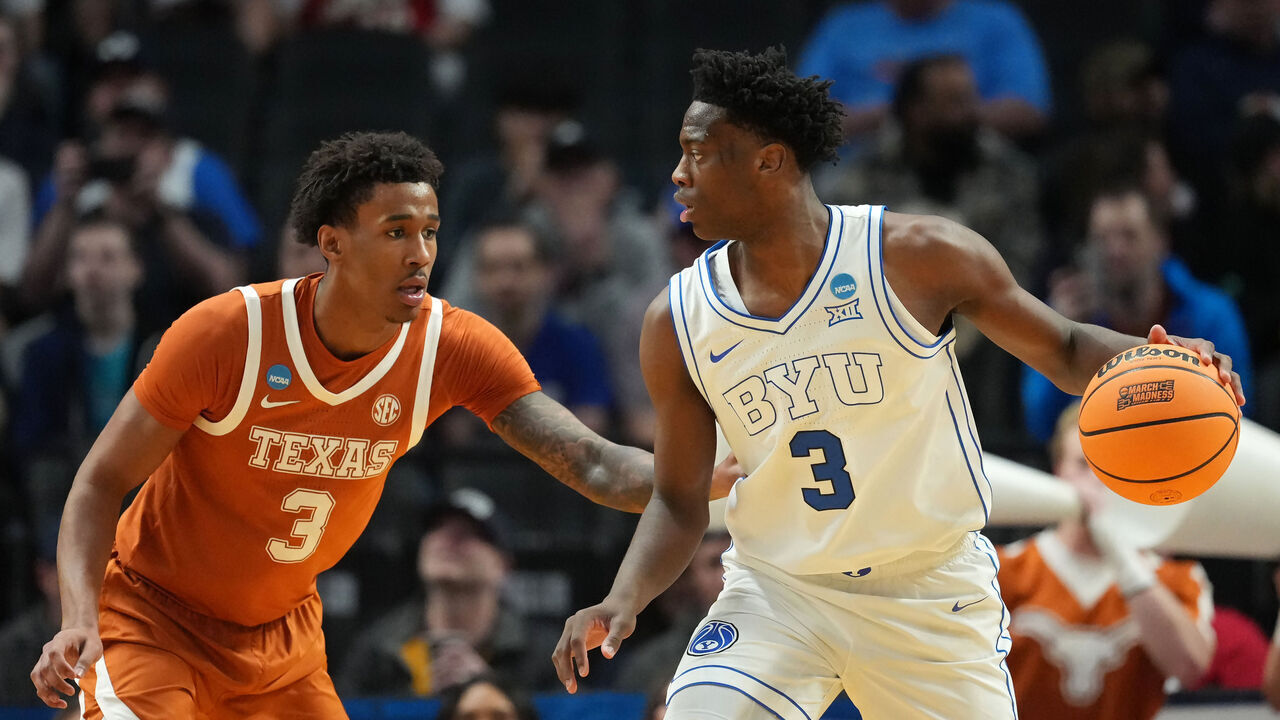 PORTLAND, OREGON - MARCH 19: AJ Dybantsa #3 of the BYU Cougars dribbles the ball while being guarded by Dailyn Swain #3 of the Texas Longhorns during the first half in the first round of the 2026 NCAA Men's Basketball Tournament at Moda Center on March 19, 2026 in Portland, Oregon.