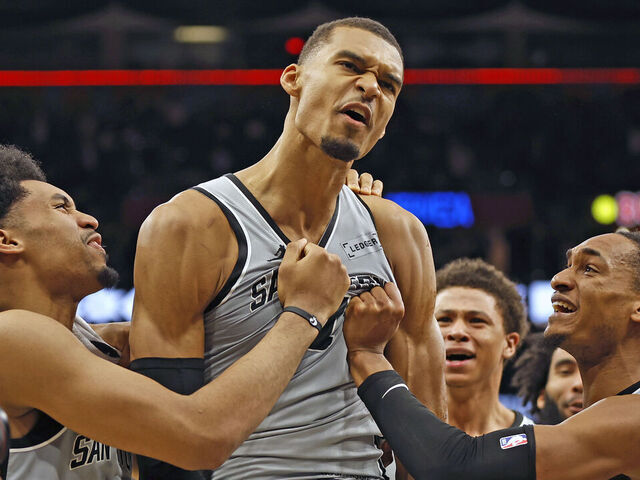 SAN ANTONIO, TEXAS - MARCH 19: Victor Wembanyama #1 of the San Antonio Spurs is surrounded by teammates after he scored the game-winning basket against the Phoenix Suns at Frost Bank Center on March 19, 2026 in San Antonio, Texas. NOTE TO USER: User expressly acknowledges and agrees that, by downloading and or using this photograph, User is consenting to terms and conditions of the Getty Images License Agreement.
