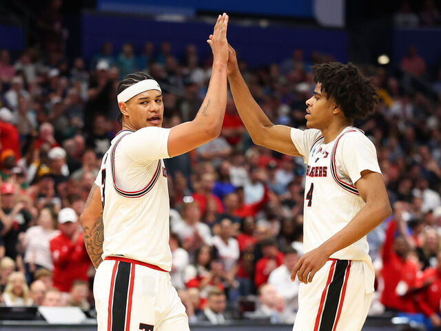 TAMPA, FLORIDA - MARCH 20: Christian Anderson #4 and LeJuan Watts #3 of the Texas Tech Red Raiders high five during the first half against the Akron Zips in the first round of the 2026 NCAA Men's Basketball Tournament at Benchmark International Arena on March 20, 2026 in Tampa, Florida.