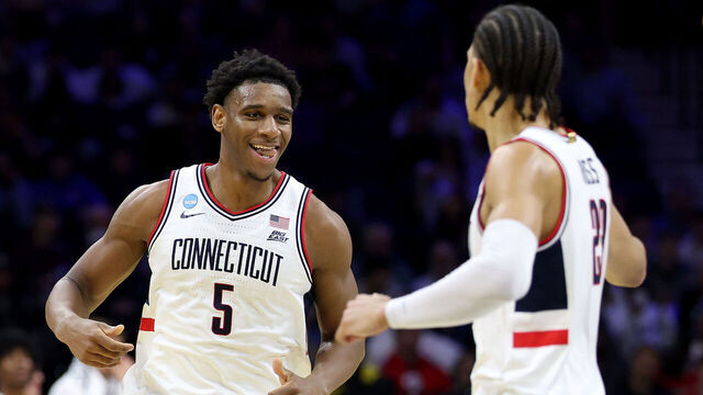 PHILADELPHIA, PENNSYLVANIA - MARCH 20: Tarris Reed Jr. #5 of the UConn Huskies reacts with Jayden Ross #23 of the UConn Huskies against the Furman Paladins during the first half in the first round of the 2026 NCAA Men's Basketball Tournament at Xfinity Mobile Arena on March 20, 2026 in Philadelphia, Pennsylvania.