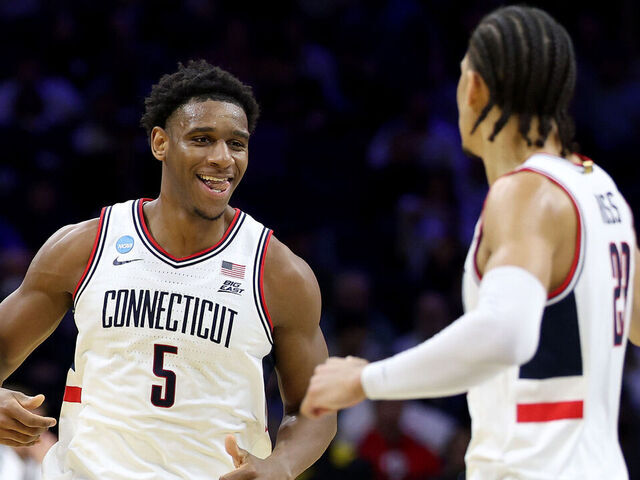 PHILADELPHIA, PENNSYLVANIA - MARCH 20: Tarris Reed Jr. #5 of the UConn Huskies reacts with Jayden Ross #23 of the UConn Huskies against the Furman Paladins during the first half in the first round of the 2026 NCAA Men's Basketball Tournament at Xfinity Mobile Arena on March 20, 2026 in Philadelphia, Pennsylvania.