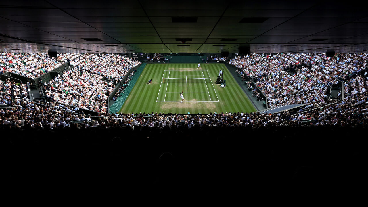 LONDON, ENGLAND - JULY 13: A general view over Centre Court as Carlos Alcaraz of Spain serves against Jannik Sinner of Italy during the Gentleman's Singles Final on day fourteen of The Championships Wimbledon 2025 at All England Lawn Tennis and Croquet Club on July 13, 2025 in London, England.