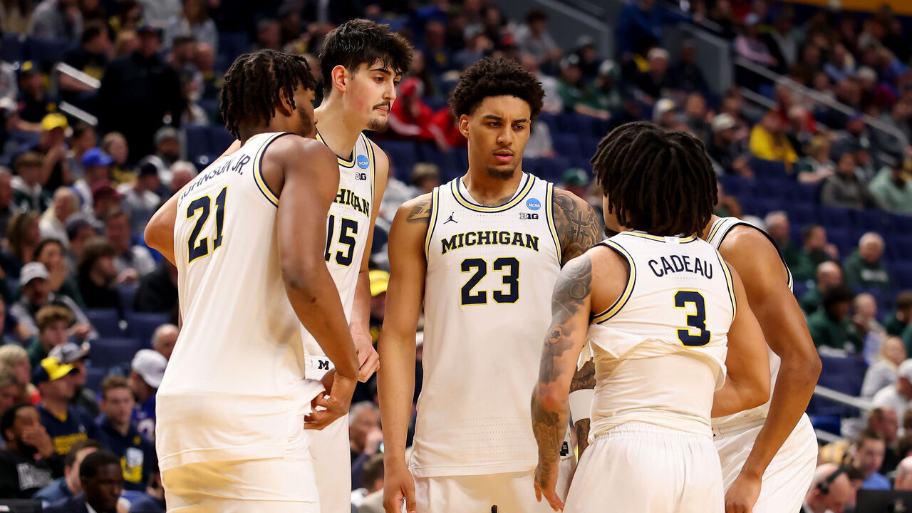 BUFFALO, NEW YORK - MARCH 21: Yaxel Lendeborg #23 of the Michigan Wolverines talks with teammates Morez Johnson Jr. #21, Aday Mara #15 and Elliot Cadeau #3 against the Saint Louis Billikens during the first half in the second round of the 2026 NCAA Men's Basketball Tournament at KeyBank Center on March 21, 2026 in Buffalo, New York.