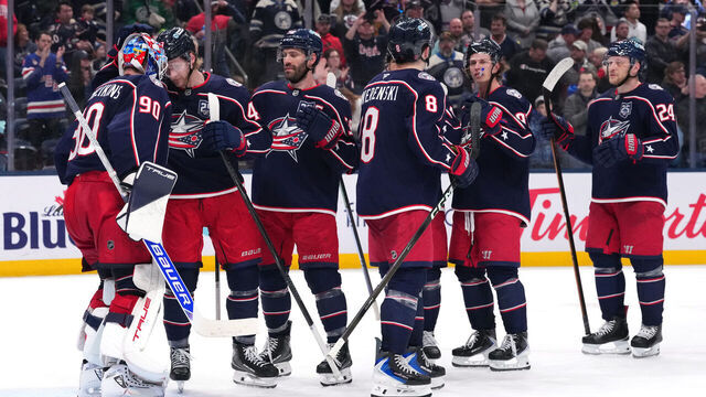 COLUMBUS, OHIO - MARCH 21: Elvis Merzlikins #90 of the Columbus Blue Jackets celebrates a win over the Seattle Kraken with his teammates after the game at Nationwide Arena on March 21, 2026 in Columbus, Ohio. Columbus won 5-2.