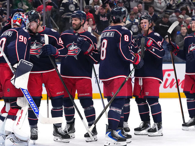 COLUMBUS, OHIO - MARCH 21: Elvis Merzlikins #90 of the Columbus Blue Jackets celebrates a win over the Seattle Kraken with his teammates after the game at Nationwide Arena on March 21, 2026 in Columbus, Ohio. Columbus won 5-2.